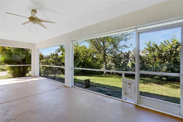 unfurnished sunroom with a ceiling fan