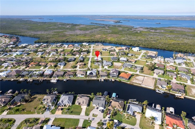 drone / aerial view with a residential view and a water view