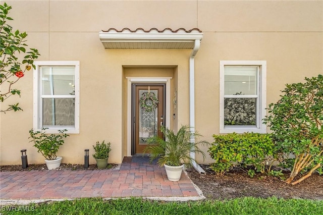 doorway to property with stucco siding