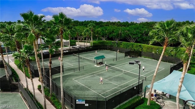 view of sport court featuring fence