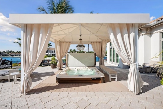 view of patio / terrace with a covered hot tub