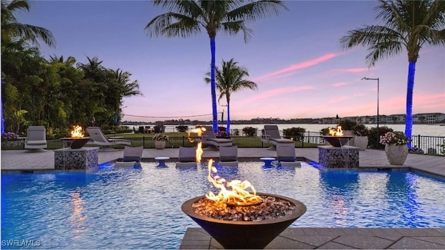 view of swimming pool with a patio, a fenced in pool, a fire pit, and fence