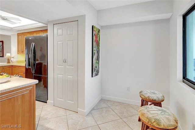 interior space with light tile patterned floors and baseboards