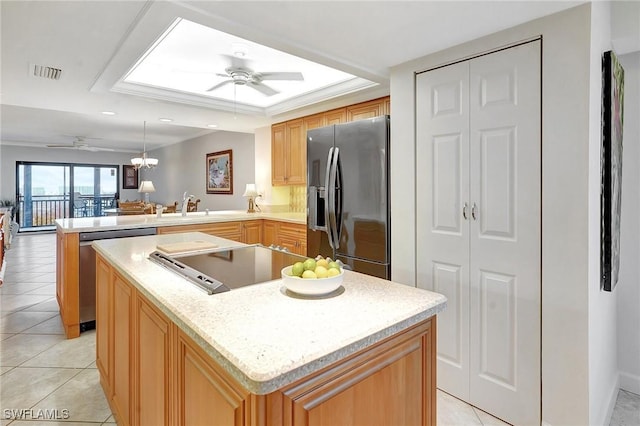 kitchen with light tile patterned floors, visible vents, a peninsula, a sink, and appliances with stainless steel finishes