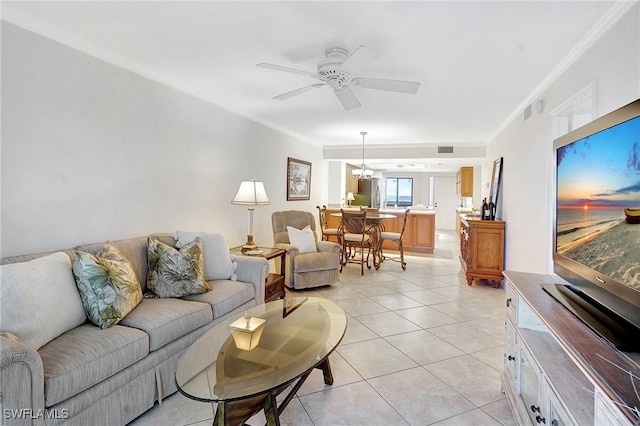 living room featuring light tile patterned flooring, ceiling fan with notable chandelier, visible vents, and ornamental molding