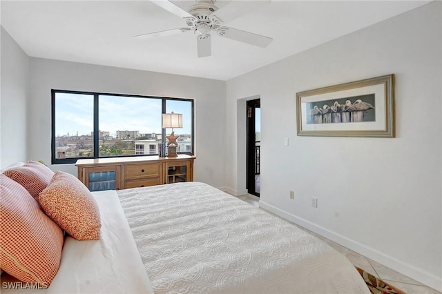 bedroom featuring a ceiling fan and baseboards