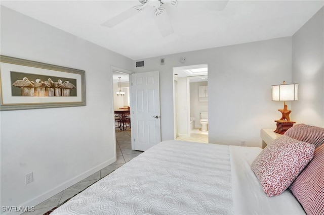 bedroom featuring visible vents, baseboards, light tile patterned floors, ensuite bath, and a ceiling fan