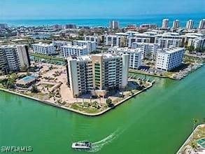 birds eye view of property with a view of city and a water view