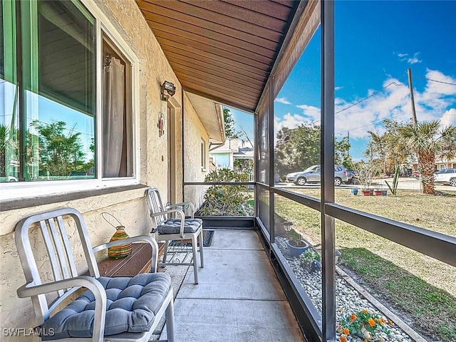 sunroom featuring wood ceiling