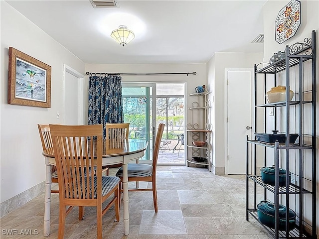 dining room with visible vents and baseboards