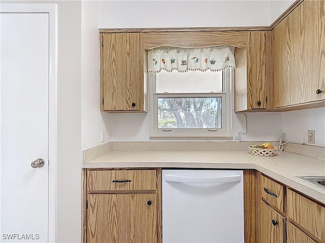 kitchen featuring dishwasher and light countertops