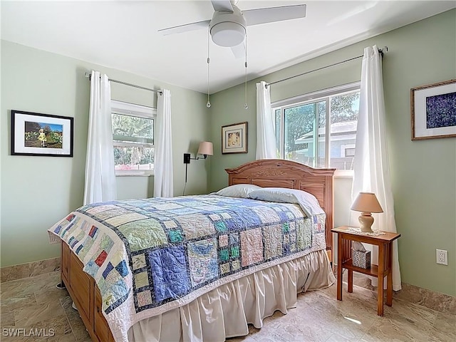 bedroom with multiple windows and ceiling fan