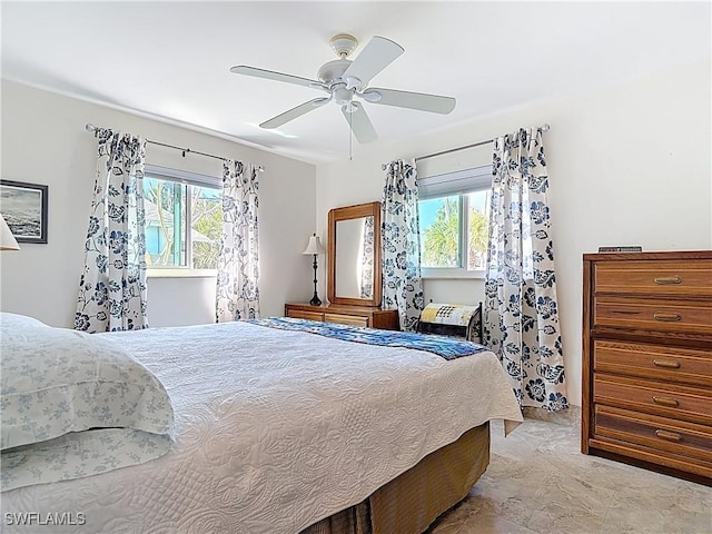 bedroom featuring multiple windows and ceiling fan