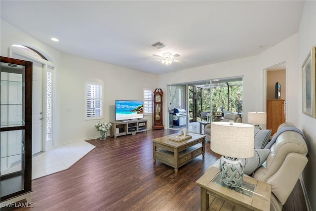 living room with visible vents, recessed lighting, baseboards, ceiling fan, and dark wood-style flooring