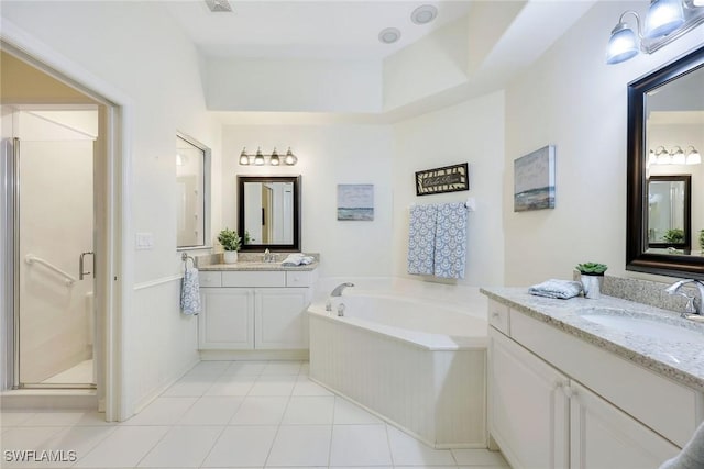 bathroom with two vanities, a sink, a shower stall, tile patterned floors, and a bath