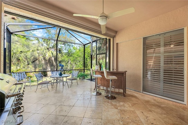 sunroom / solarium featuring ceiling fan