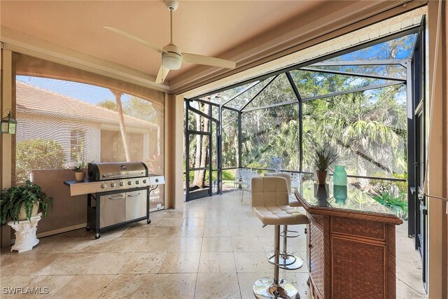 sunroom with a ceiling fan