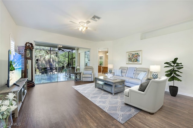 living area featuring wood finished floors, visible vents, and ceiling fan