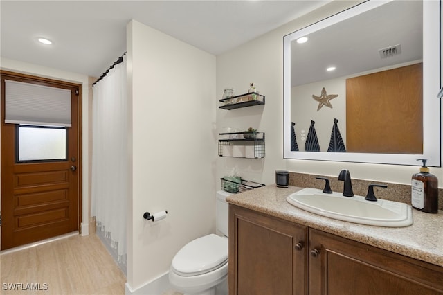 full bath with visible vents, toilet, recessed lighting, wood finished floors, and vanity