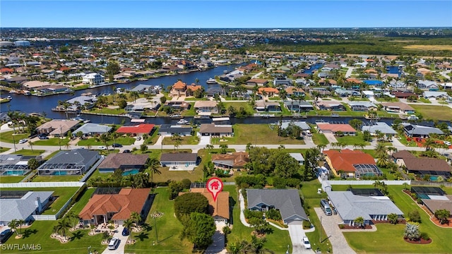 birds eye view of property with a residential view and a water view