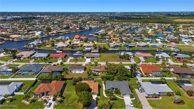 drone / aerial view with a residential view and a water view