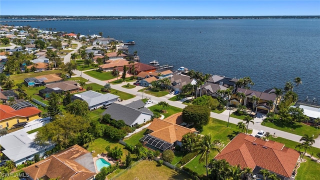 drone / aerial view featuring a residential view and a water view