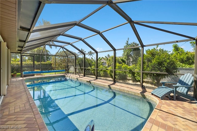 view of pool with a covered pool, a patio, and a lanai