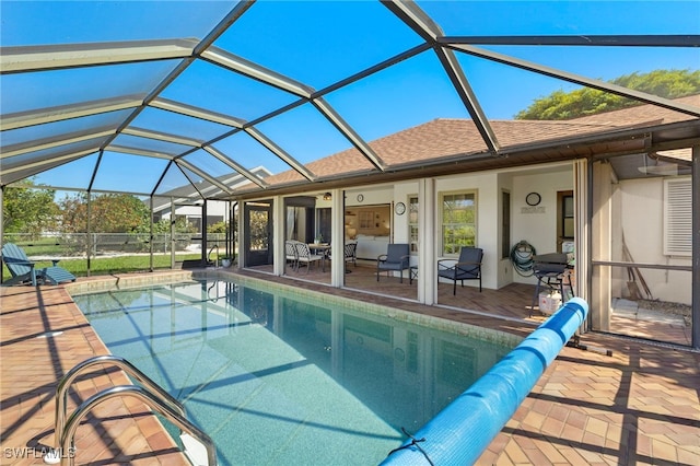 outdoor pool with a patio area and a lanai