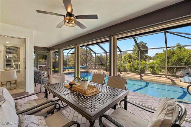 sunroom featuring ceiling fan