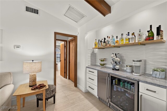 bar featuring visible vents, beverage cooler, lofted ceiling with beams, decorative backsplash, and a dry bar