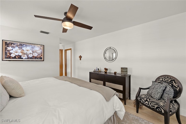 bedroom with a ceiling fan, light wood-style floors, and visible vents