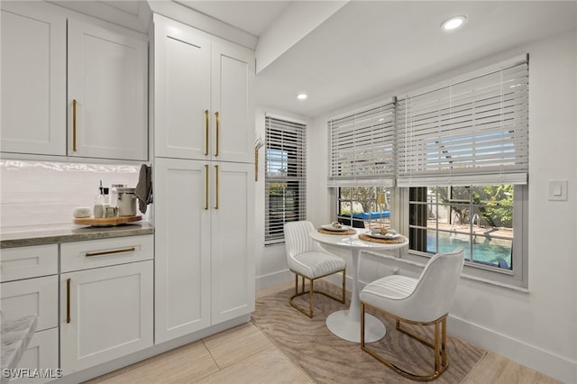 interior space featuring tasteful backsplash, recessed lighting, baseboards, and light tile patterned flooring