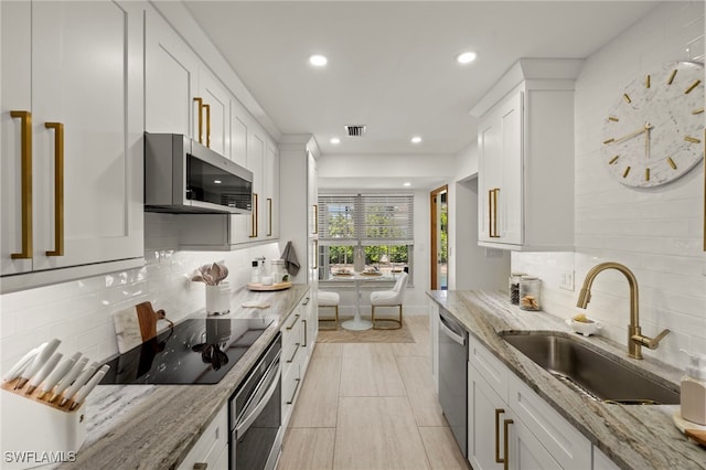 kitchen featuring a sink, visible vents, white cabinetry, and stainless steel appliances