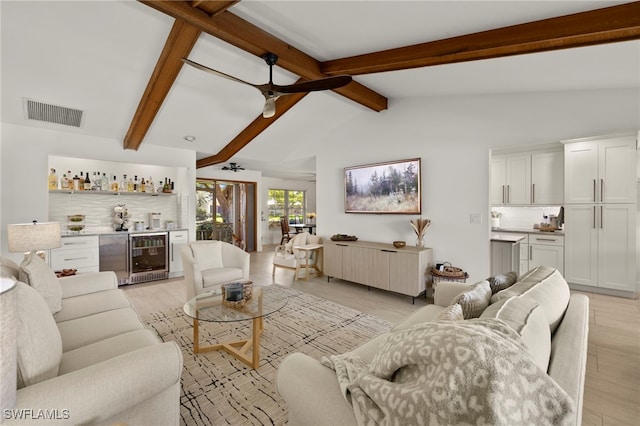 living area with a dry bar, beverage cooler, visible vents, and light wood-style flooring