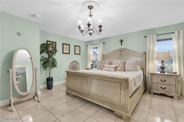bedroom featuring a notable chandelier, baseboards, and light tile patterned floors