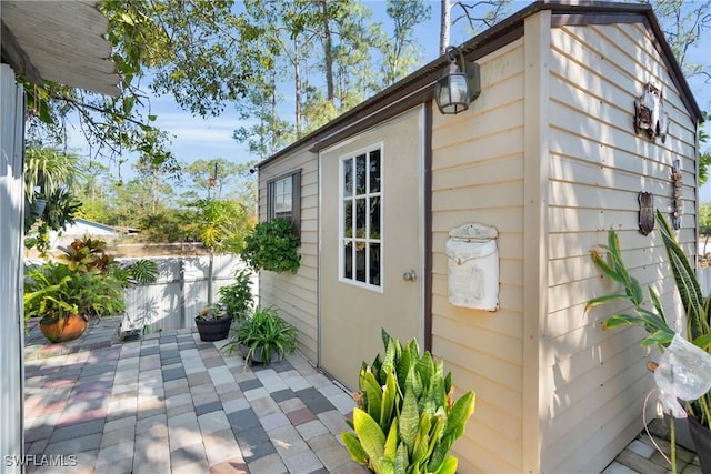 view of home's exterior featuring a patio and fence