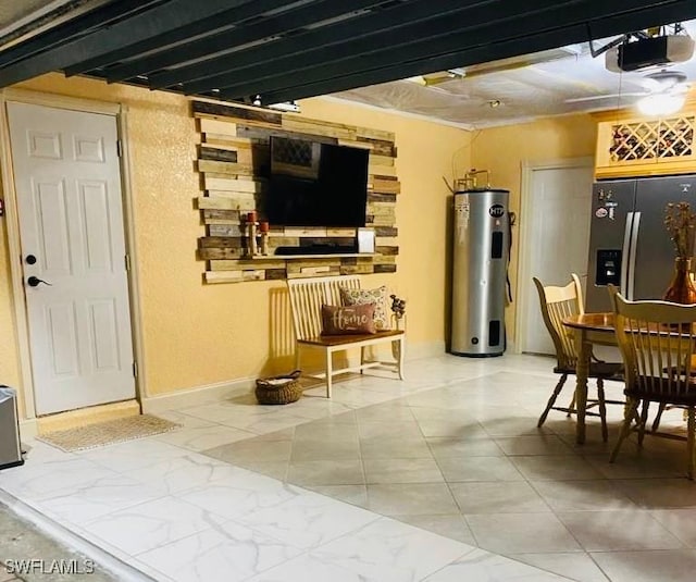 dining area featuring baseboards, water heater, and marble finish floor