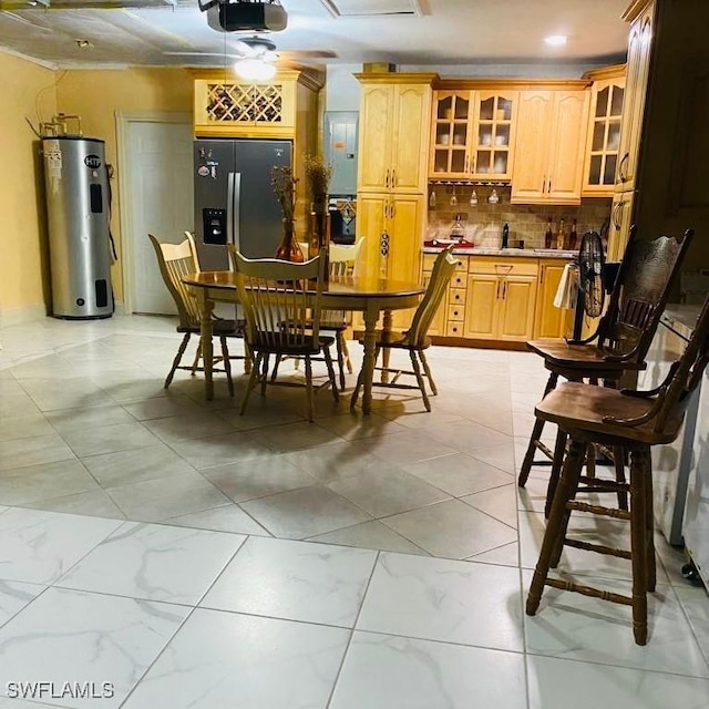 dining space featuring water heater and marble finish floor