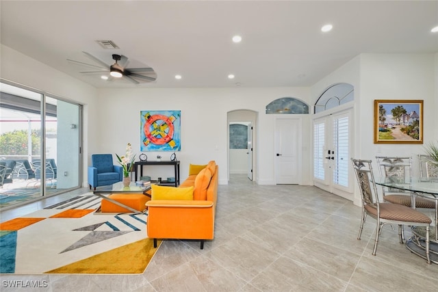 living room featuring recessed lighting, visible vents, arched walkways, and a ceiling fan