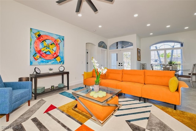 living room with arched walkways, recessed lighting, baseboards, and ceiling fan