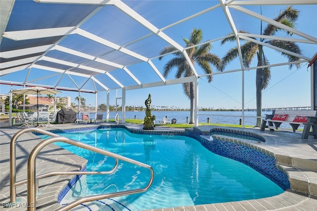 pool with a lanai, an in ground hot tub, a patio, and a water view