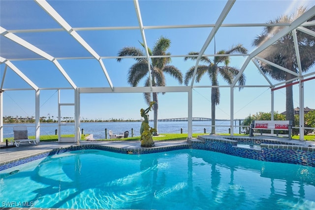 outdoor pool featuring glass enclosure, a water view, an in ground hot tub, and a patio area