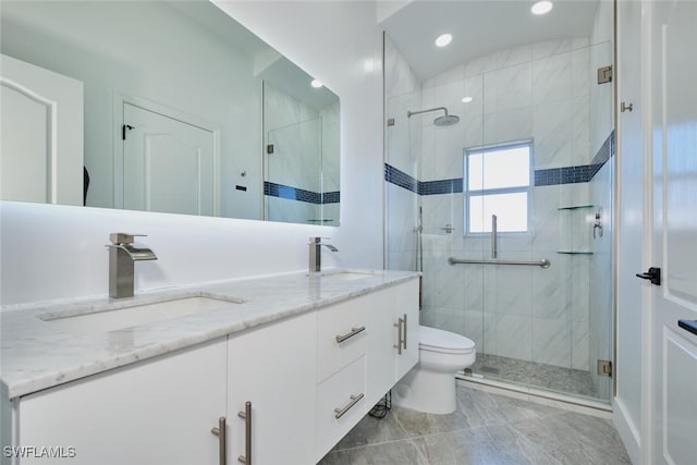 full bath featuring a sink, toilet, a shower stall, and double vanity