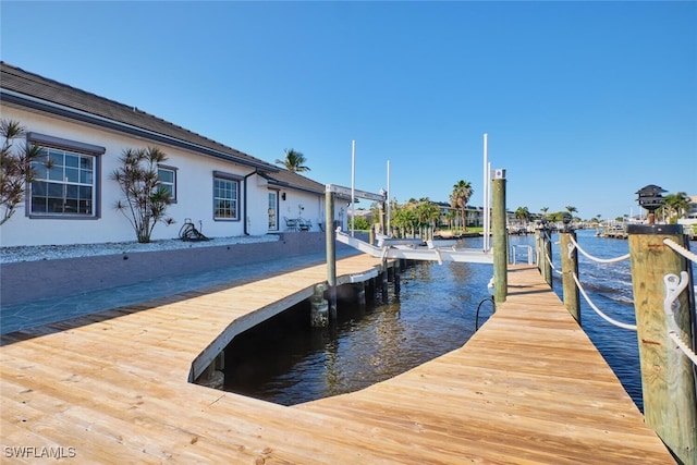 dock area featuring a water view and boat lift