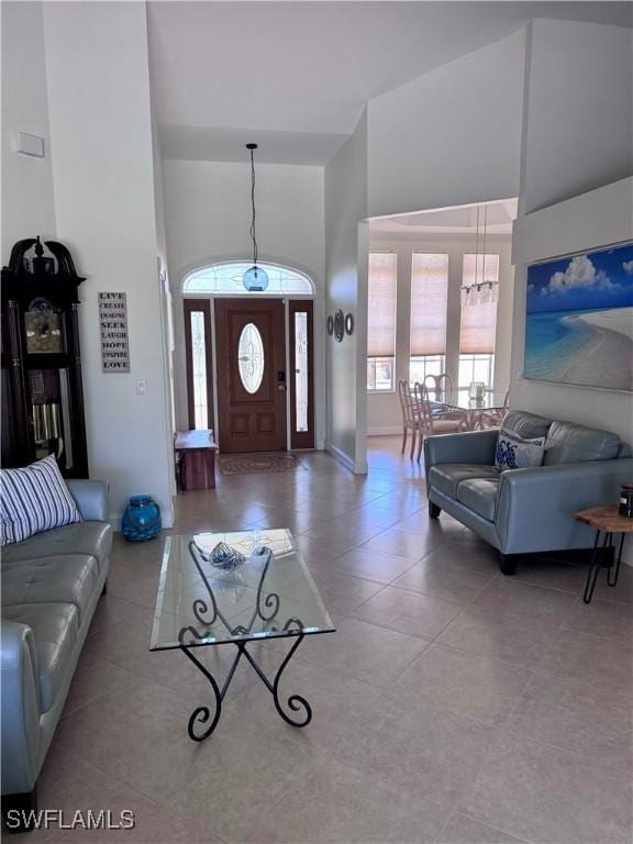 entrance foyer with a wealth of natural light, tile patterned floors, and a high ceiling