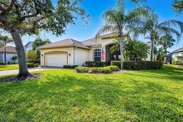 mediterranean / spanish-style home with a front lawn, an attached garage, driveway, and stucco siding