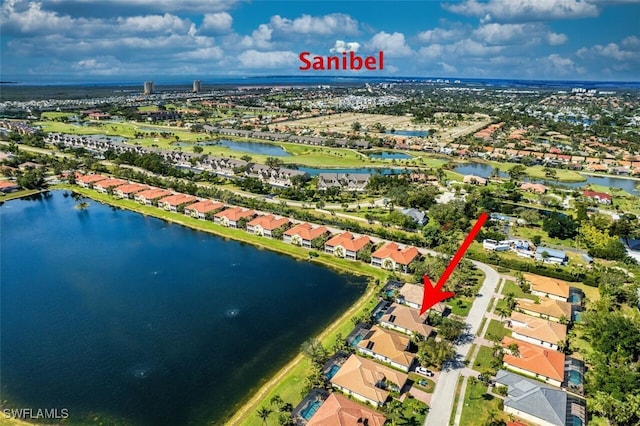 drone / aerial view featuring a water view and a residential view