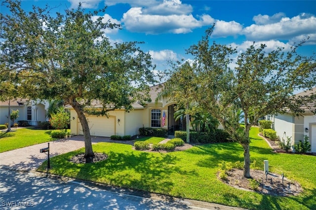 obstructed view of property featuring a front lawn, decorative driveway, a garage, and stucco siding