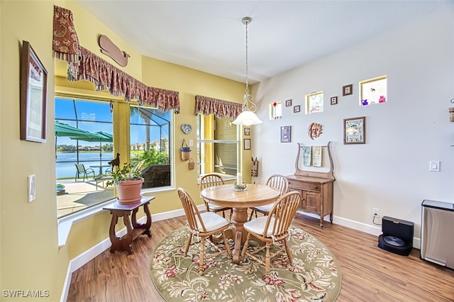 dining area with wood finished floors and baseboards