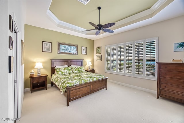 bedroom with baseboards, a raised ceiling, carpet floors, and ornamental molding